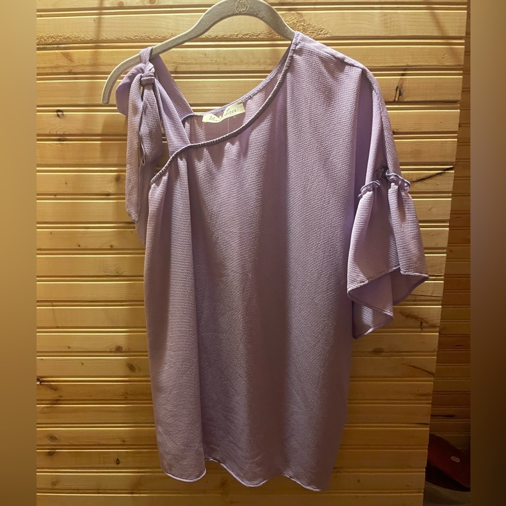 Light purple. One sleeve shirt. Size Small